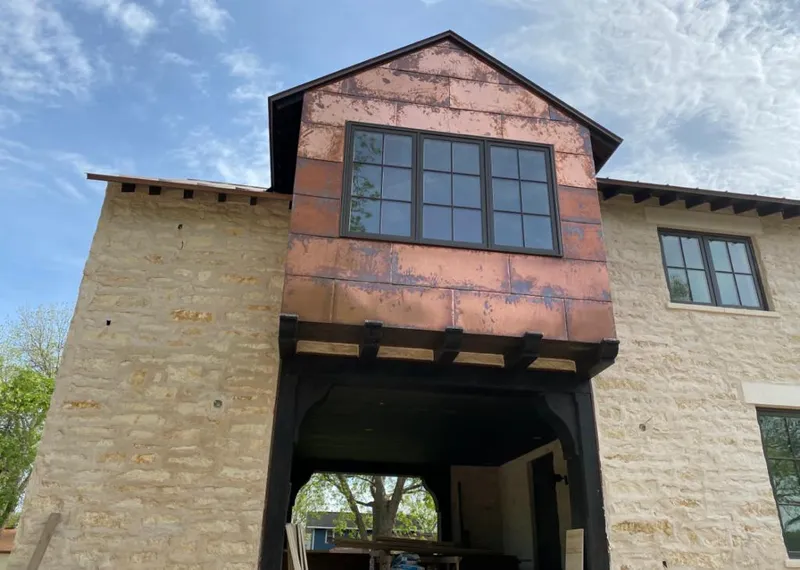 Copper metal panel facade on a stone building for Metal Roof Coating in Atlanta